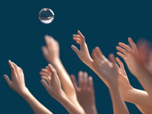 Childrens hands reaching for a bubble